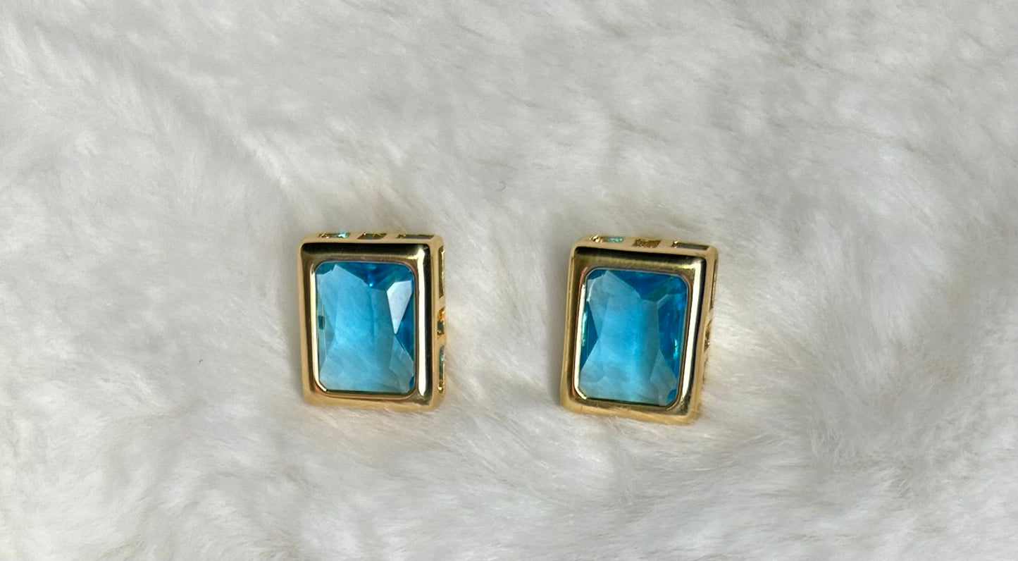 Earring with gold-plated blue stone.